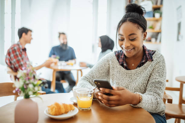 istock African American woman using smart phone in cafe 1366825045