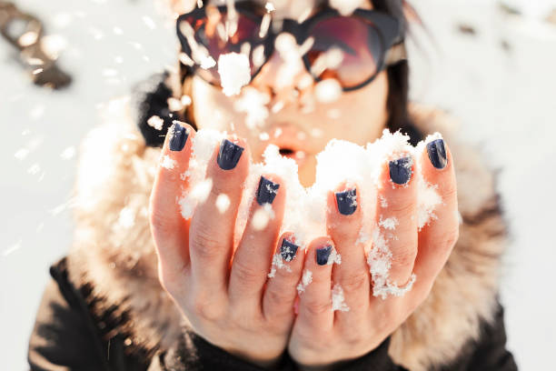 istock Girl with snow in her hands 1366826033