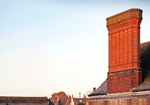 Close up chimney on roof and sky, brick wall of the house
