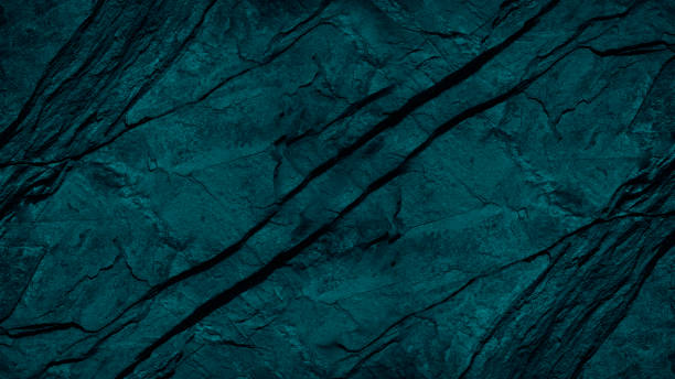 istock Blue green background. Toned folded rock surface. Stone texture with cracks. Close-up. Dark teal granite background 1366829980