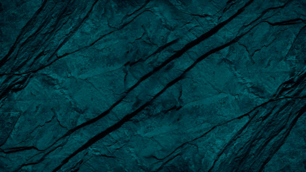 Blue green background. Toned folded rock surface. Stone texture with cracks. Close-up. Dark teal granite background Blue green background. Toned folded rock surface. Stone texture with cracks. Close-up. Dark teal granite background with space for design. rock formation stock pictures, royalty-free photos & images