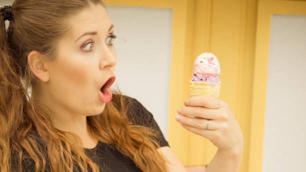 istock Shocked woman looking at ice cream 1366830227