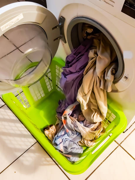 istock Freshly washed laundry in a washing machine and laundry basket 1366830531