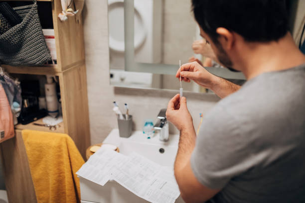 istock Close-up of an unrecognizable man doing a coronavirus antigen test at home. New normal - concept. 1366832859