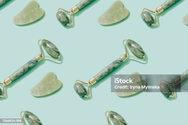 Pattern Made With Jade Gua Sha Tool And Facial Roller On Pastel Green Background Facial Massage Kit For Lifting Massage Therapy Made From Natural Stones Personal Skin Care Antiaging Tools Stock Photo - Download Image Now