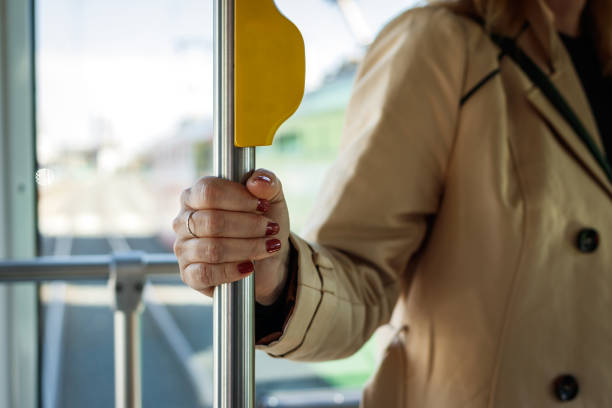 Woman holding pole in city bus