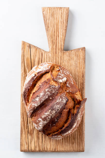 istock Sliced rye bread on cutting board, closeup.. 1366834833