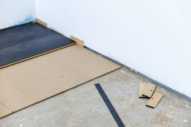 istock Installing a new dark wood laminate flooring with fiber insulation below 1366835677
