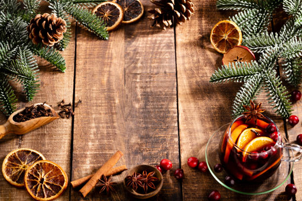 istock Christmas mulled wine with spices on a wooden rustic table. 1366835940