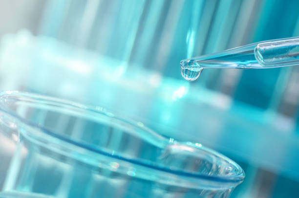 istock Scientific laboratory research. Antiviral vaccine development. A drop falls from a laboratory pipette into a flask, close-up 1366837396