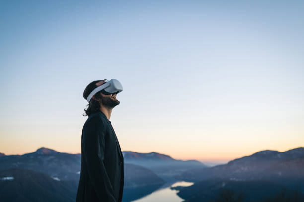 businessman wears vr glasses on mountain ridge - rural watch imagens e fotografias de stock