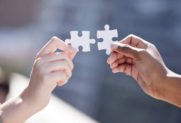 istock Cropped shot of two unrecognizable businessmen completing a puzzle 1366840185