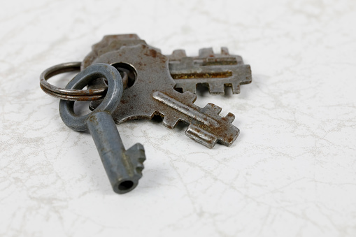The old keys used for the old padlocks are shown against the marble background.