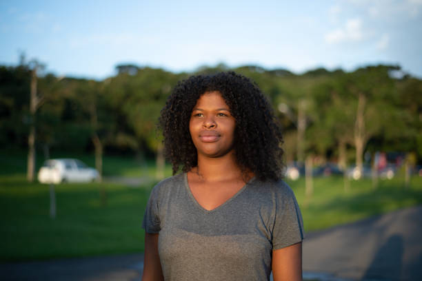 istock Young woman walking in the park 1366841259