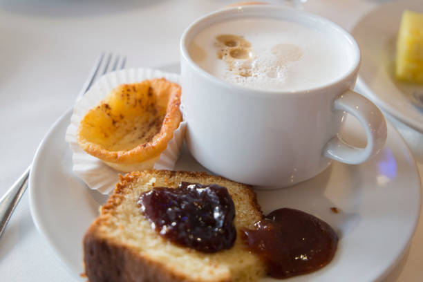 Cappuccino coffee sponge cake and sweets on table breakfast
