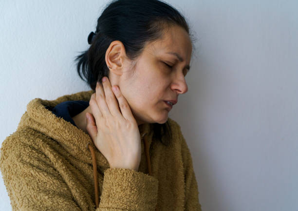 istock Woman rubbing neck 1366843777