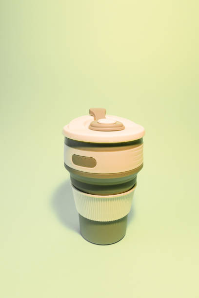 istock Reusable silicone cup for coffee on a light background. Vertical photo 1366844439