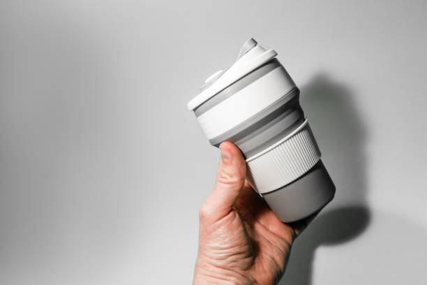 istock Reusable silicone cup for coffee in hand on a white background. 1366844442