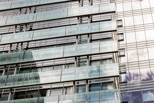 Closeup modern office building with reflection, abstract background with copy space, full frame horizontal composition