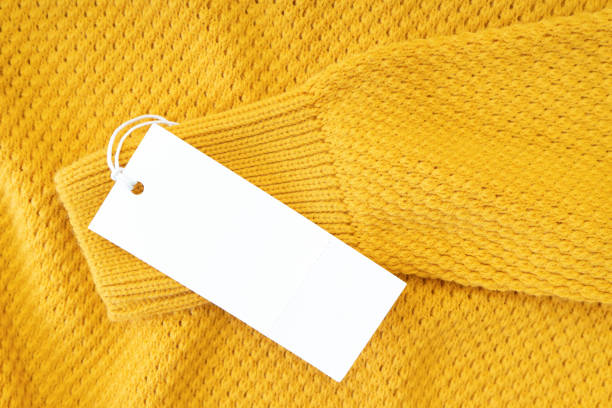 istock White blank rectangular clothing tag on yellow knitted sweater isolated on white background 1366844614
