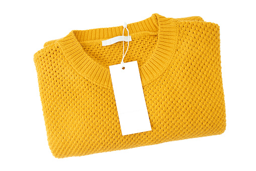 White blank rectangular clothing tag, label mockup template on yellow knitted sweater isolated on white background . Price tag label with copy space for text