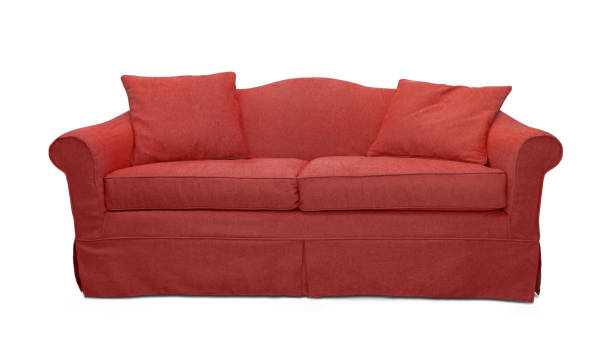 istock Red sofa with pillows isolated on white background. Red textile couch isolated 1366844672