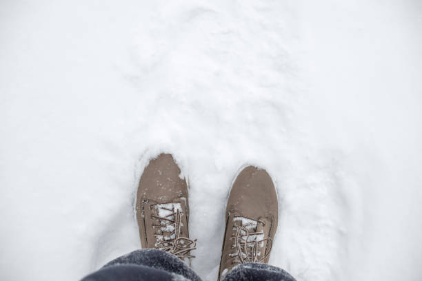 istock gray women's boots on the snow 1366845630