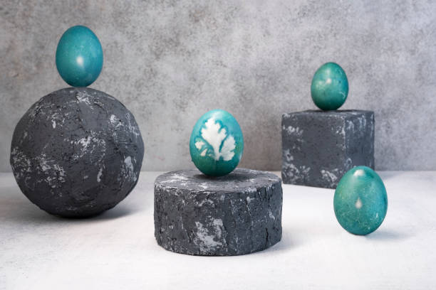 istock Blue Easter eggs on grey podium or pedestal. Natural coloring Easter eggs with red cabbage in blue color. Parsley leaf design 1366845978