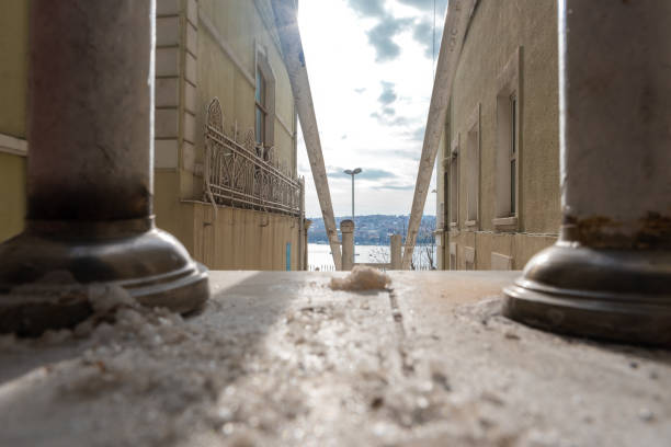 istock frozen snow on the ground and sea view from between two buildings 1366849007