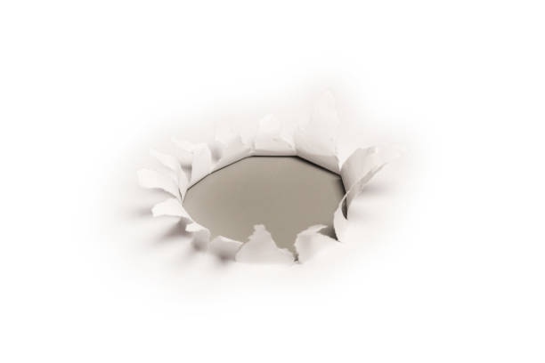 istock A hole in a white paper on a grey background. 1366850750