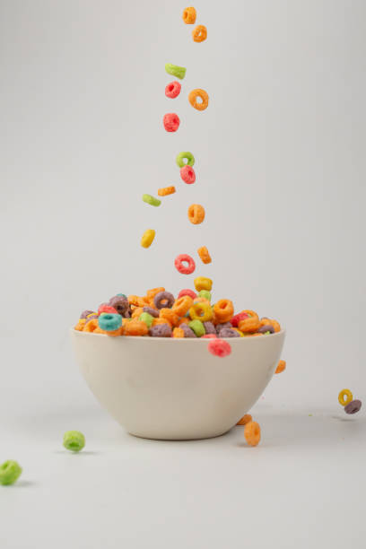 istock Colorful cereal box for morning breakfast. Corn flakes falling to the white bowl. Motion. 1366850763