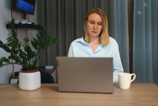 istock Pretty woman using laptop at home. 1366851568
