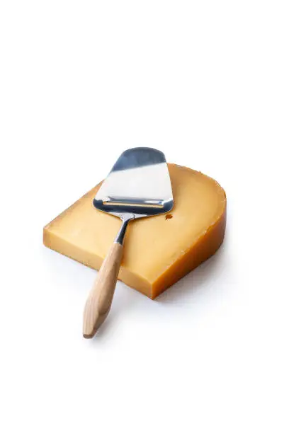 One Piece of Dutch Gouda cheese with a cheese-slicer, isolated on a white background