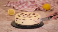 istock Pastry chef cuts cherry cheesecake. 1366851790