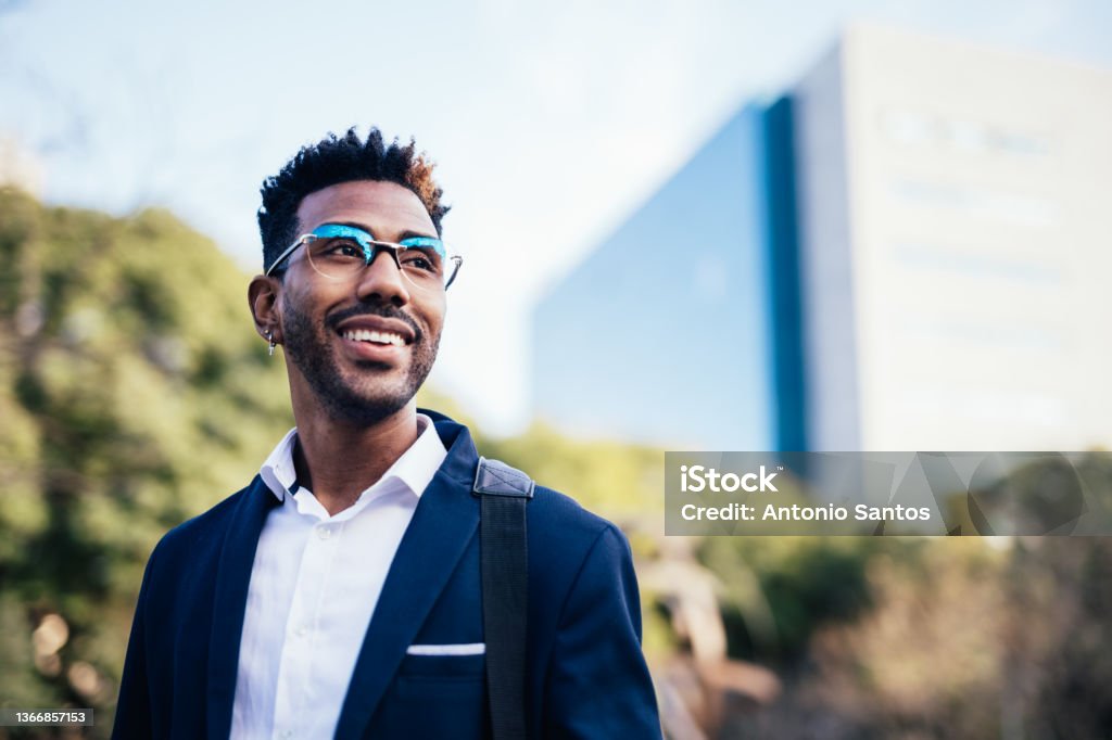 Portrait of dreamy young black man looking at infinity in a park Young Adult Stock Photo