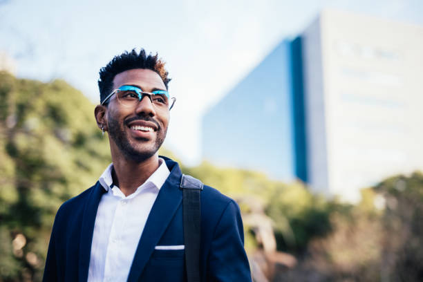 portrait of dreamy young black man looking at infinity in a park - professional occupation business one person young adult imagens e fotografias de stock