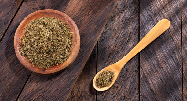 istock Thymus - Dried thyme herb in wooden bowl 1366859830