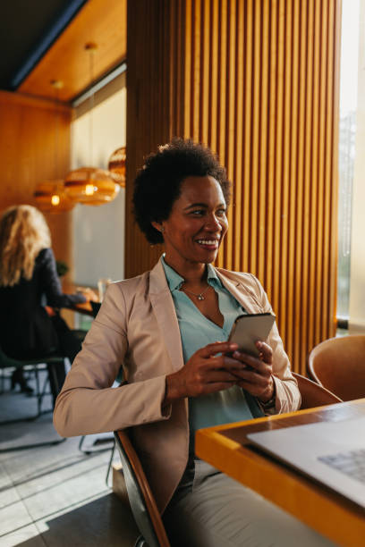 istock Businesswoman using a smartphone at cafe 1366860810