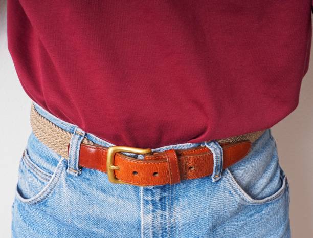 istock Persons mid section with a belt pulled tight indicating a loss in weight 1366861546