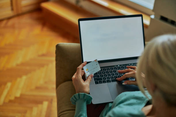 istock Woman using her laptop and shopping online 1366861953