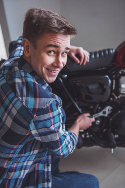 istock Man with motorbike 1366861975