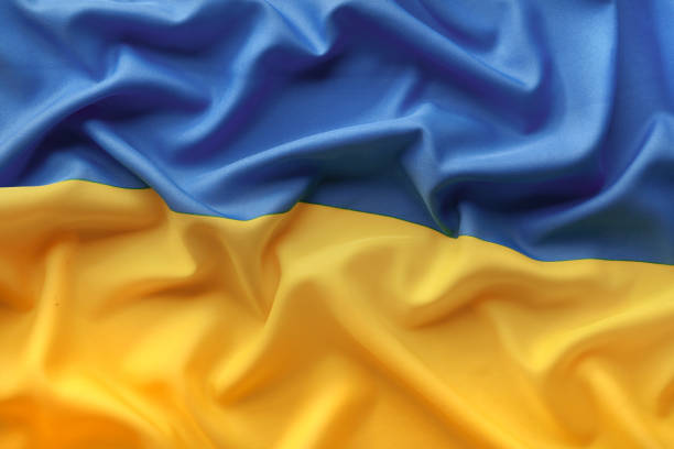 Flag of Ukraine from above with folds stock photo