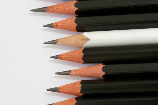 istock White pencil in a group of black pencils 1366866305