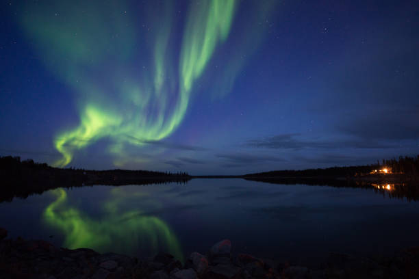 istock Aurora Borealis reflecting in lake, Canada 1366870314