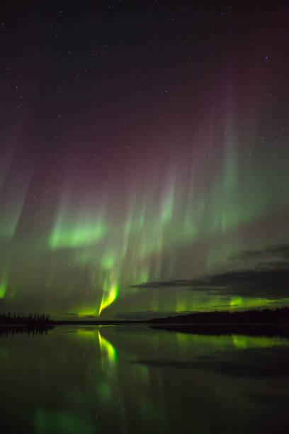 istock Aurora Borealis reflecting in lake, Canada 1366870546