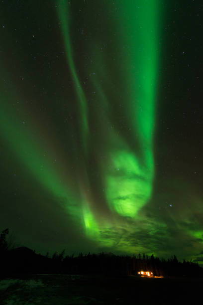 istock Spooky aurora borealis over cabin, Yukon, Canada 1366871307