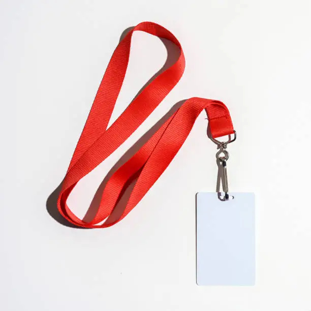Red lanyard with blank badge isolated on white background