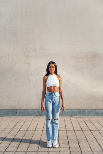 istock young black woman standing looking at the camera 1366871641