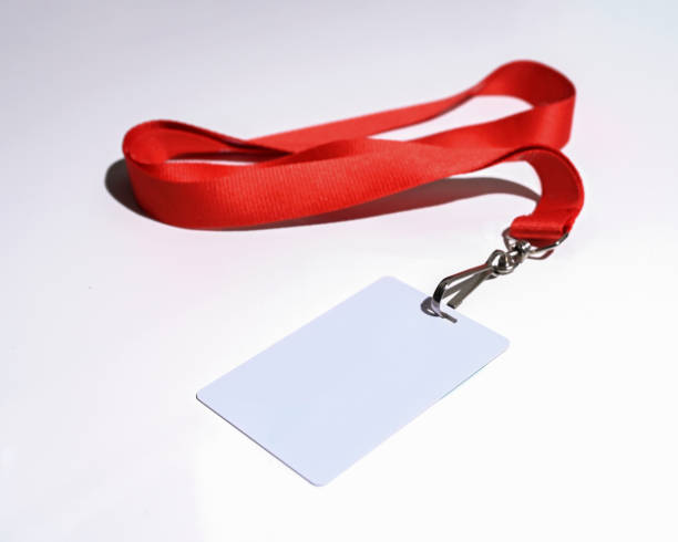 Red lanyard with blank badge isolated closeup stock photo
