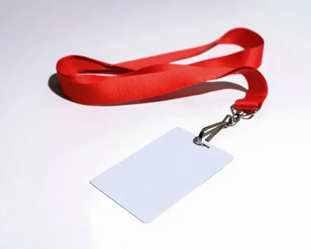 Red lanyard with blank badge isolated on white background closeup